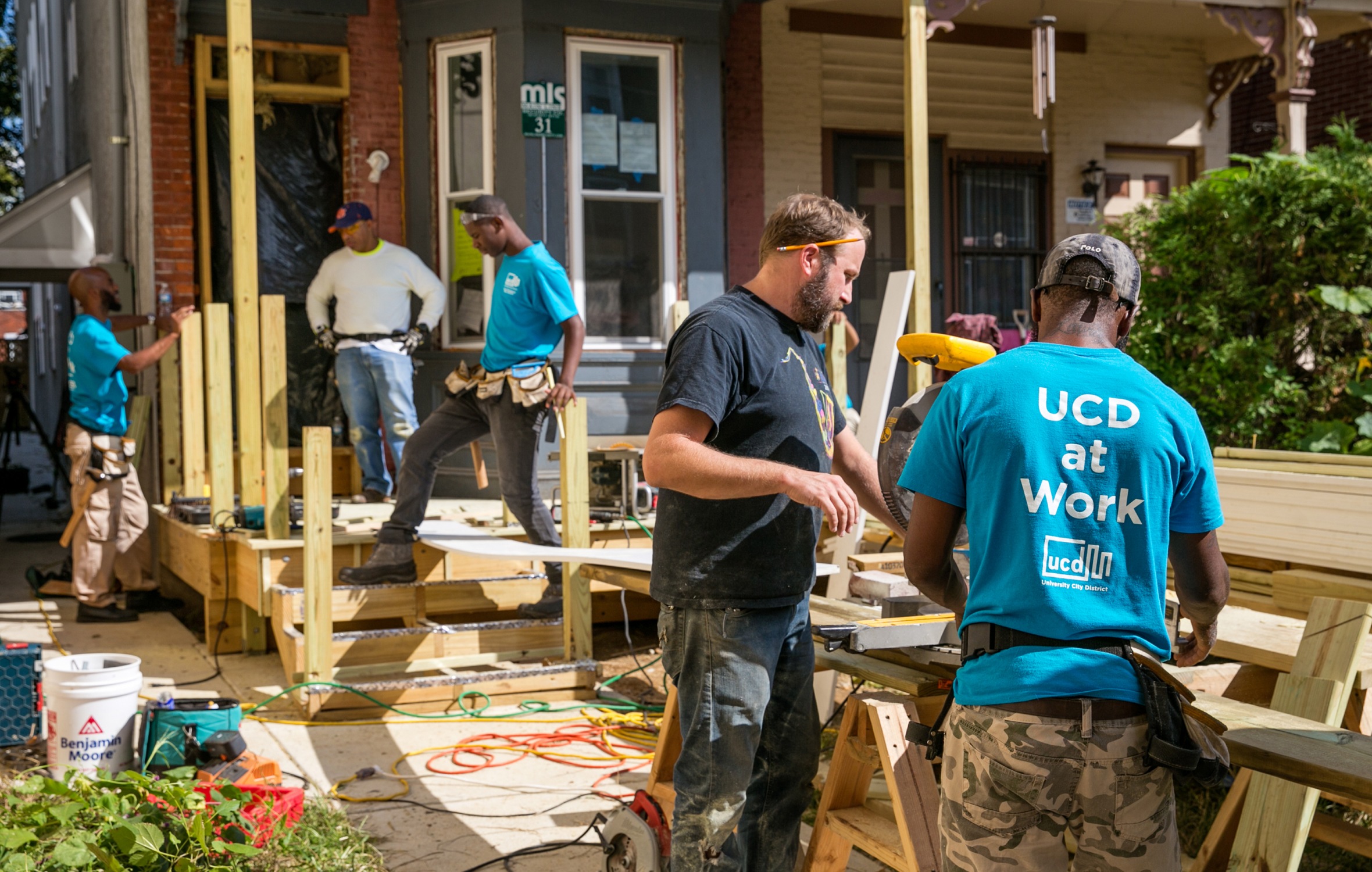 Construction workers with UCD shirts building a home.