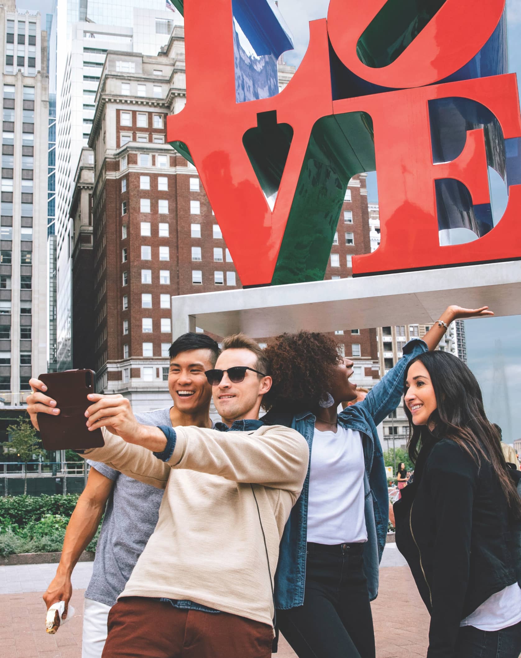 Visitors to Philadelphia taking a photo in front of the Love Statue