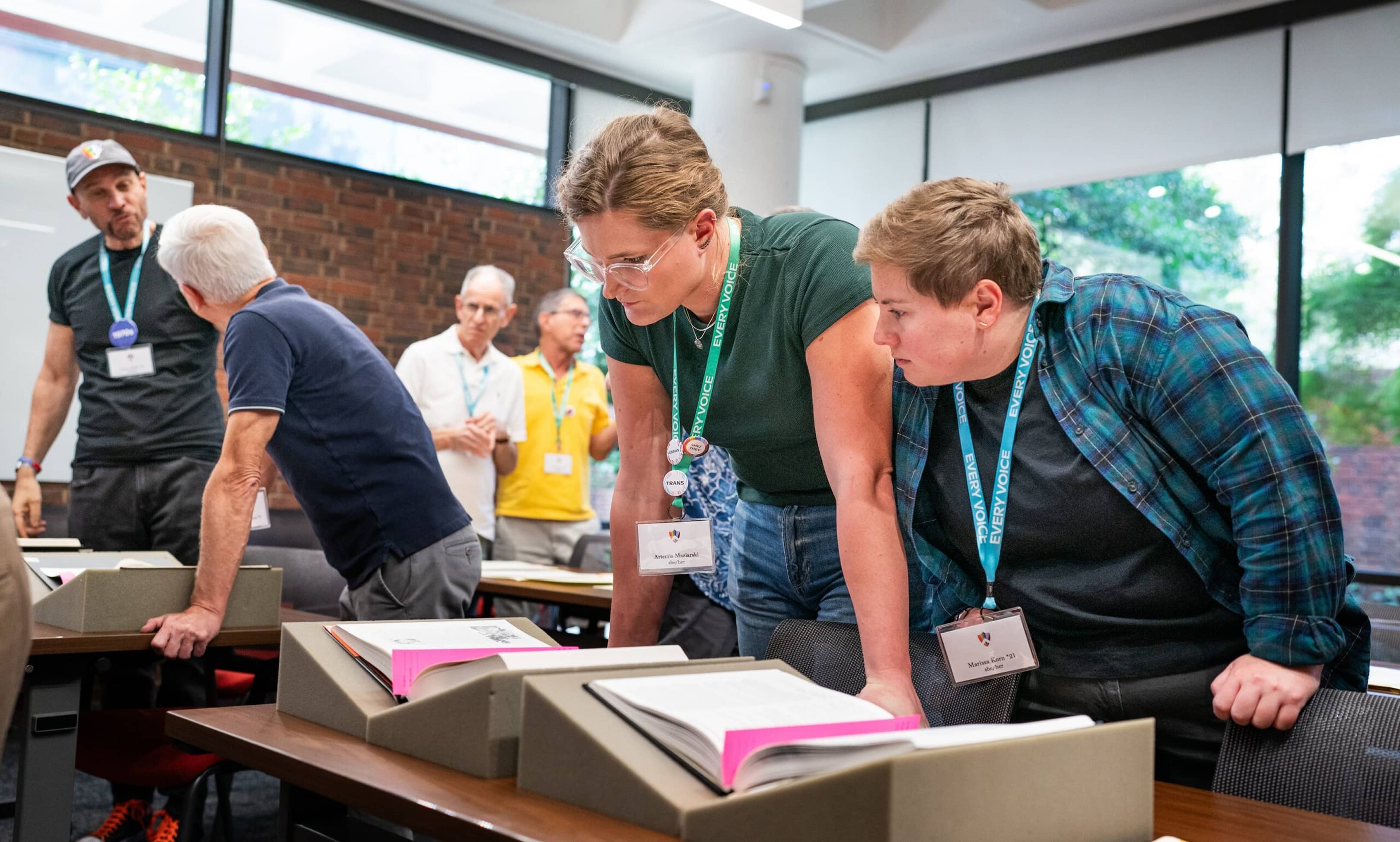 PUA Every Voice client image of attendees looking at books