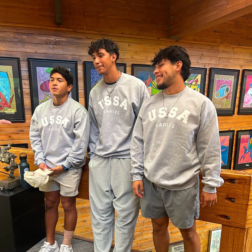 Three men in matching gray 