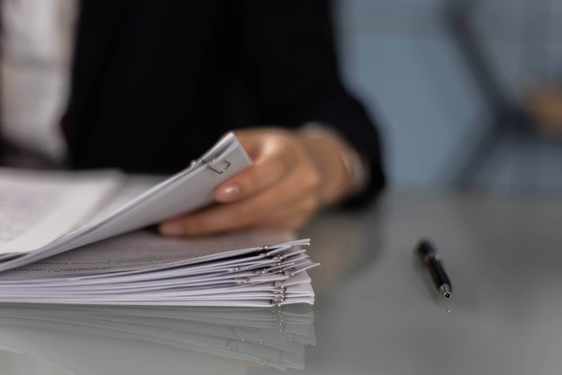 Woman sorting through a stack of proposals.