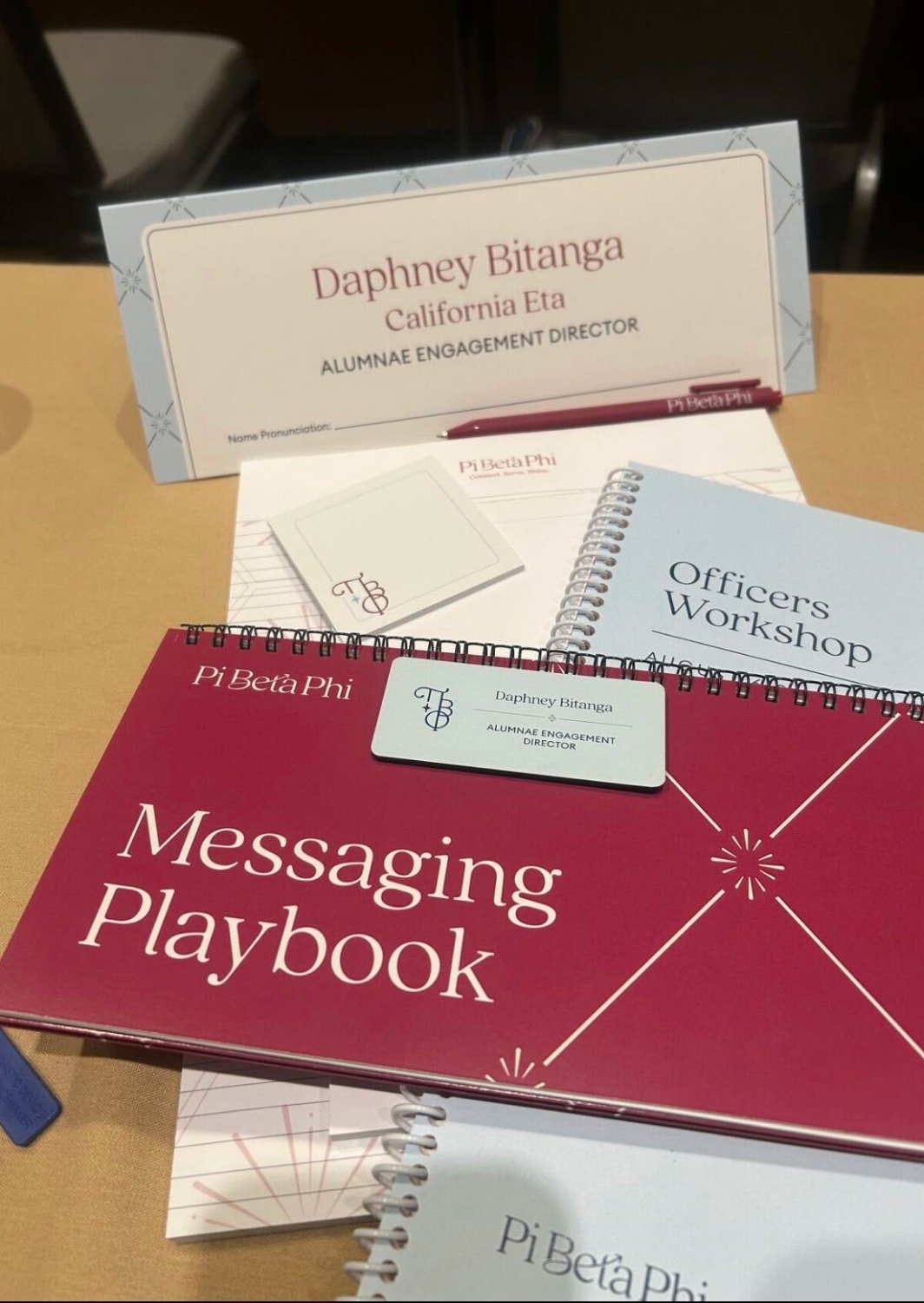 Conference merchandise and event materials featuring Pi Phi branding and visual identity.