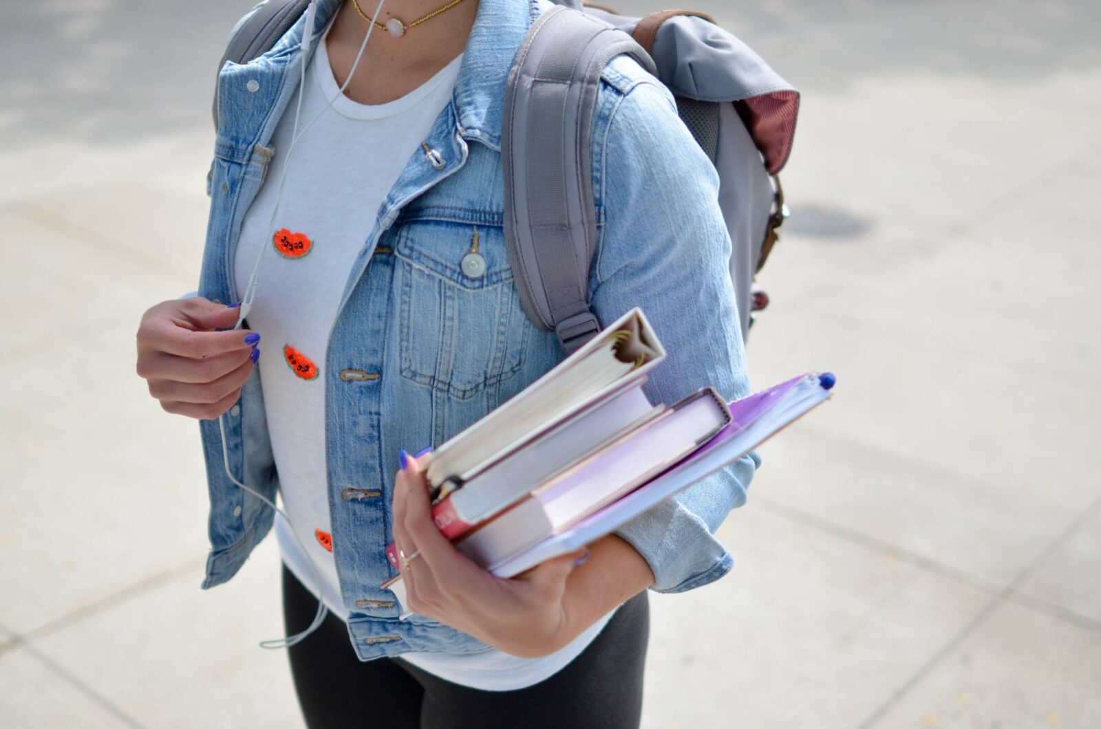 Student with books walking on campus